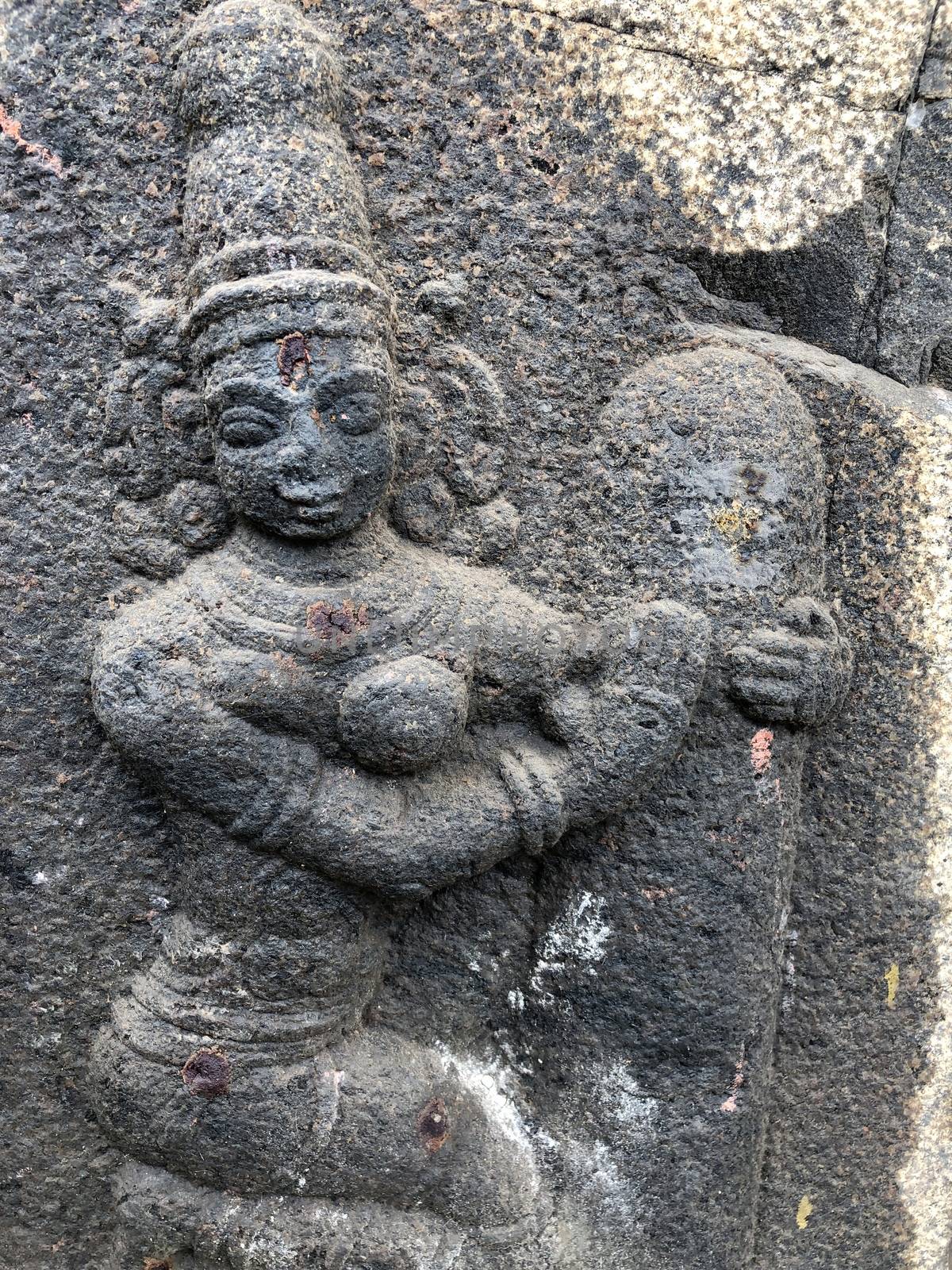 Ancient stone carvings of beautiful sculptures found in the temple in Tamilnadu. Beautiful bas-relief sculptures carved in the granite stone walls.