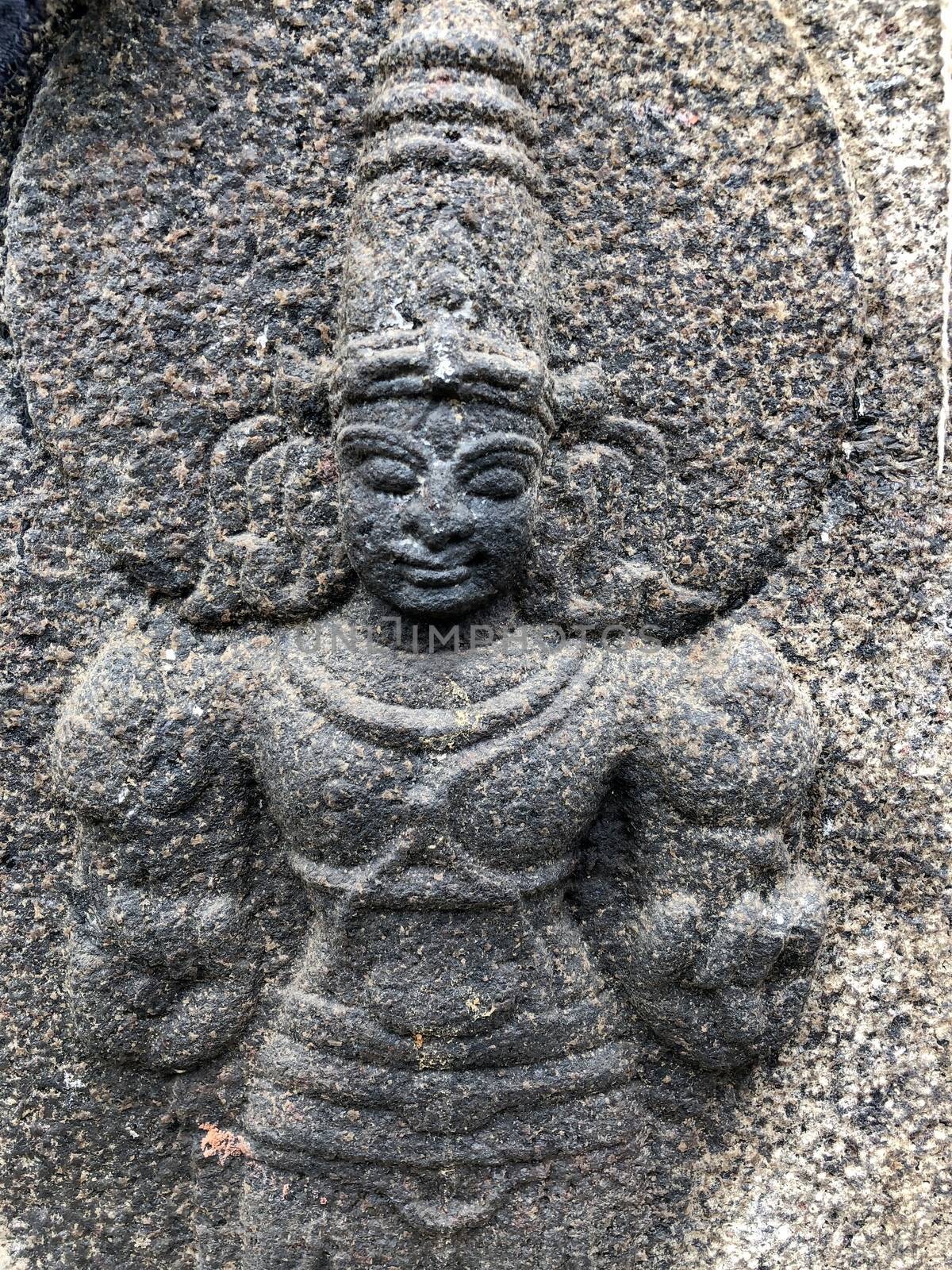 Ancient stone carvings of beautiful sculptures found in the temple in Tamilnadu. Beautiful bas-relief sculptures carved in the granite stone walls.