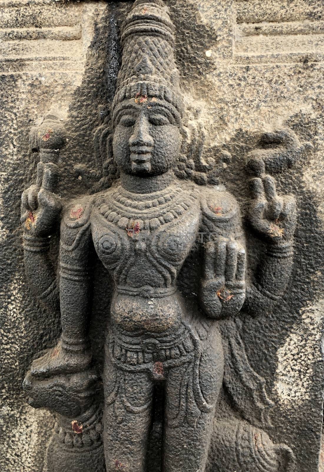 God holding the Bull deity sculpture. Bas relief sculpture carved in the stone walls of Shiva temple, Tamil nadu by prabhakaran851