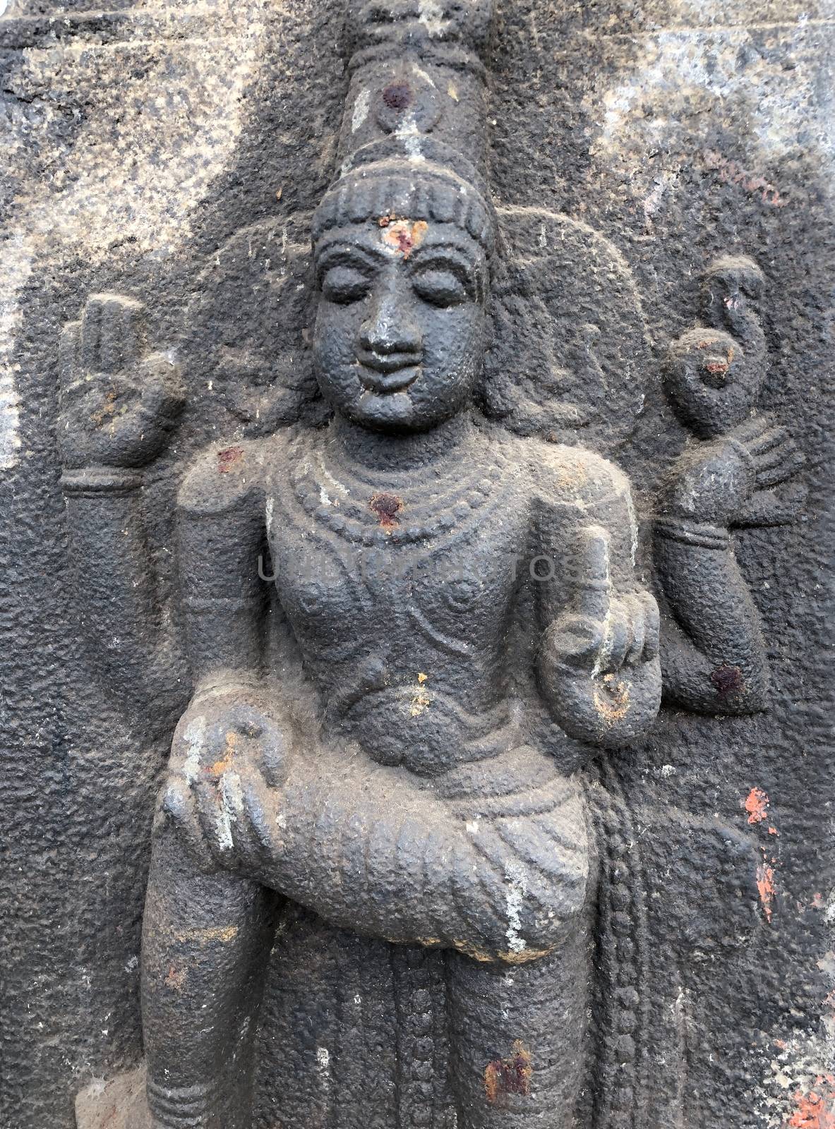 Bas relief sculpture of Hindu God carved in the stone wall of Shiva temple, Tamil nadu by prabhakaran851