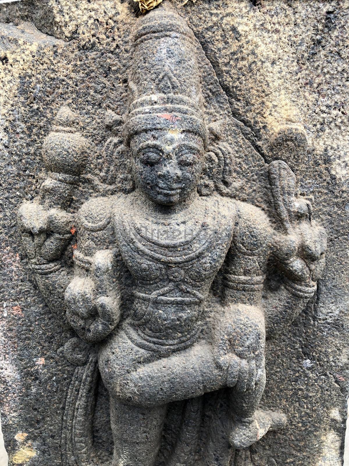 Ancient stone carvings of beautiful sculptures found in the temple in Tamilnadu. Beautiful bas-relief sculptures carved in the granite stone walls.