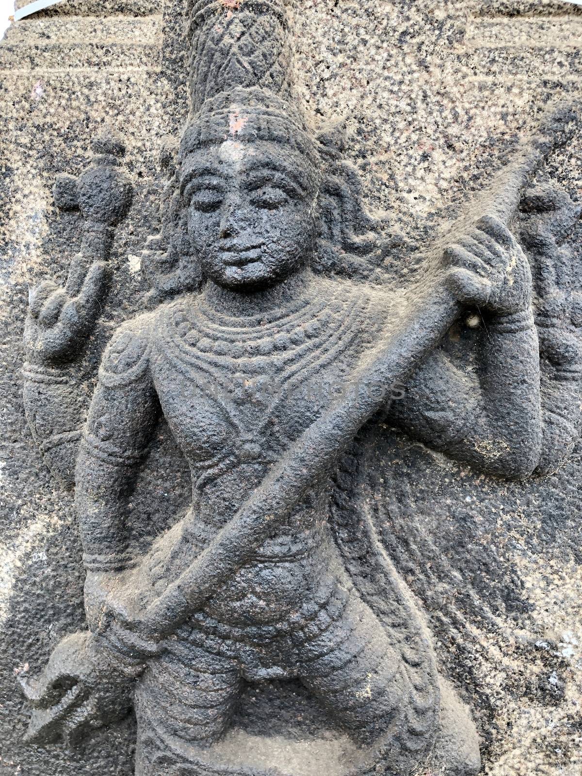 Ancient stone carvings of beautiful sculptures found in the temple in Tamilnadu. Beautiful bas-relief sculptures carved in the granite stone walls.