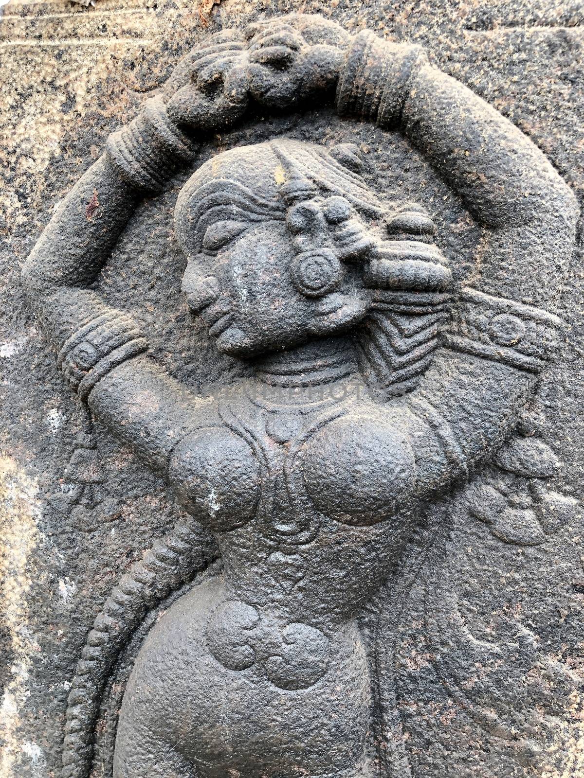 Sculpture of Woman posed dance steps. Bas relief sculpture carved in the stone walls at Shiva temple in Tamil nadu by prabhakaran851