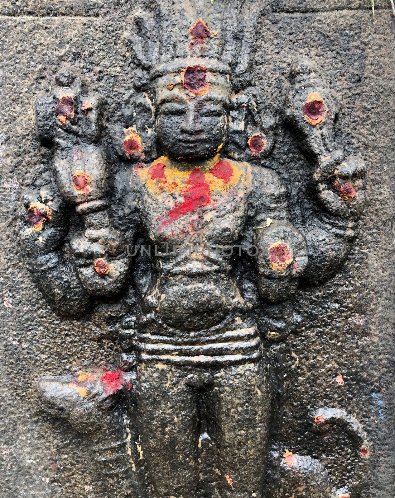 God sculpture with decorations during festival. Bas relief sculpture carved in the stone walls at Shiva temple in Tamil nadu by prabhakaran851