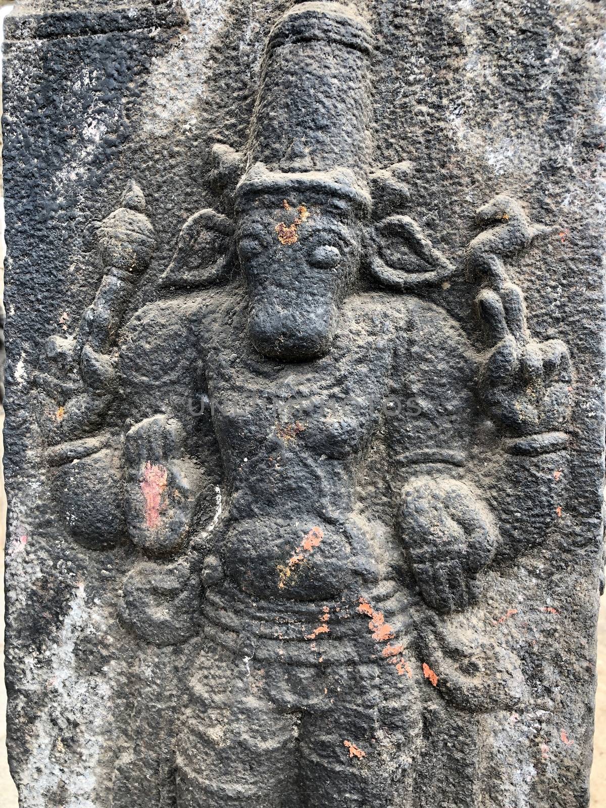 God with calf head sculpture. Bas relief sculpture carved in the stone walls at Shiva temple in Tamil nadu by prabhakaran851