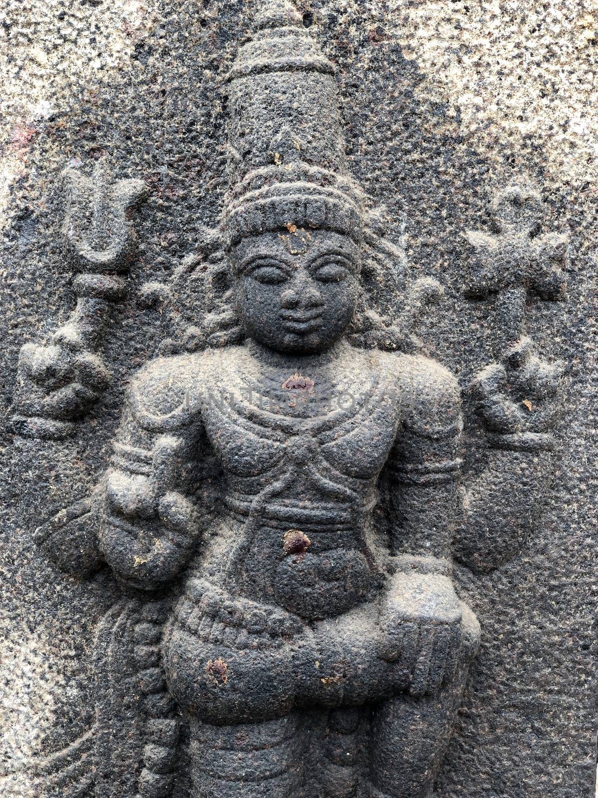 Hindu God standing in one leg sculpture. Bas relief sculpture carved in the walls of Shiva temple at Tamil nadu by prabhakaran851
