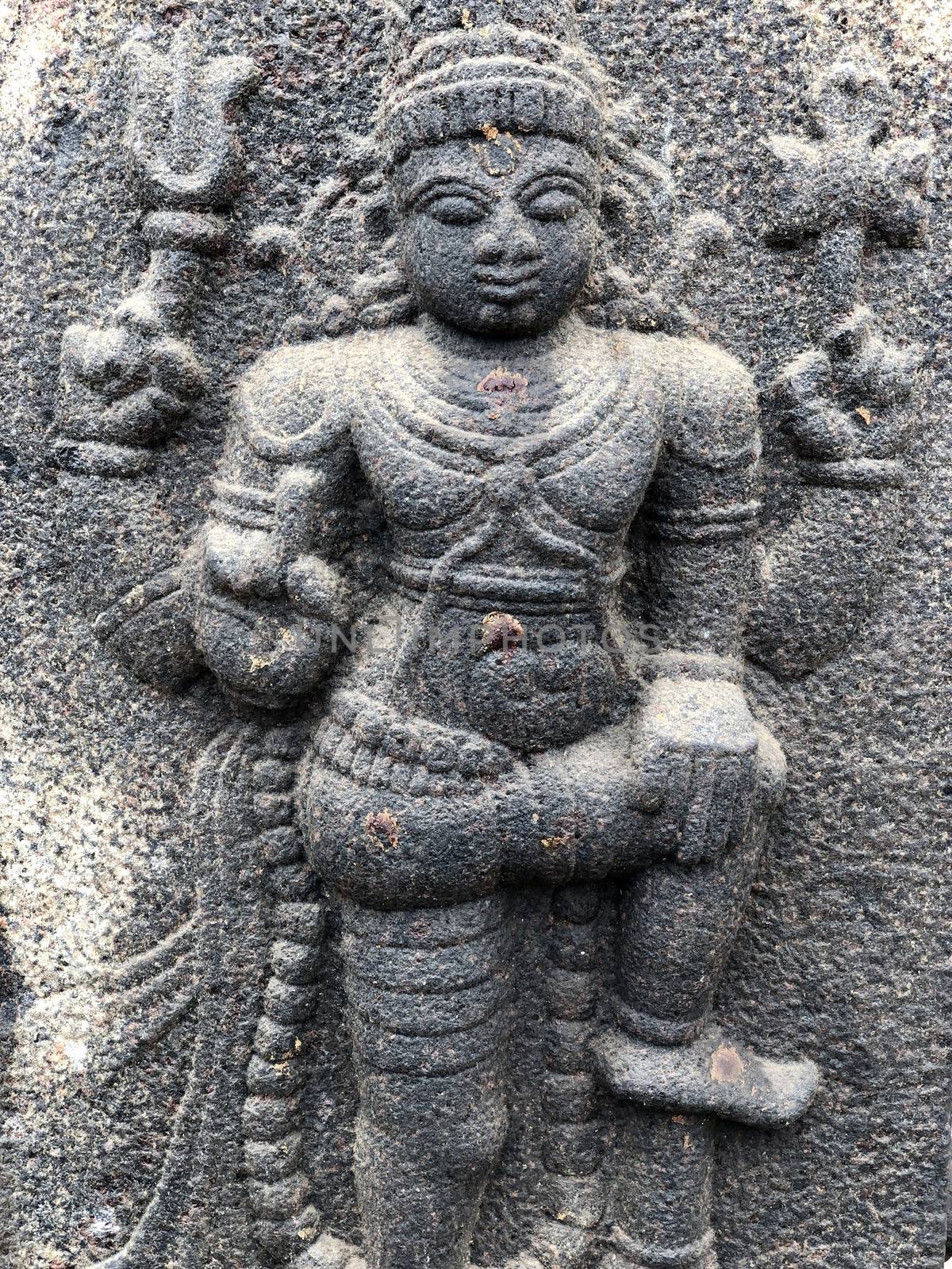 Ancient stone carvings of beautiful sculptures found in the temple in Tamilnadu. Beautiful bas-relief sculptures carved in the granite stone walls.