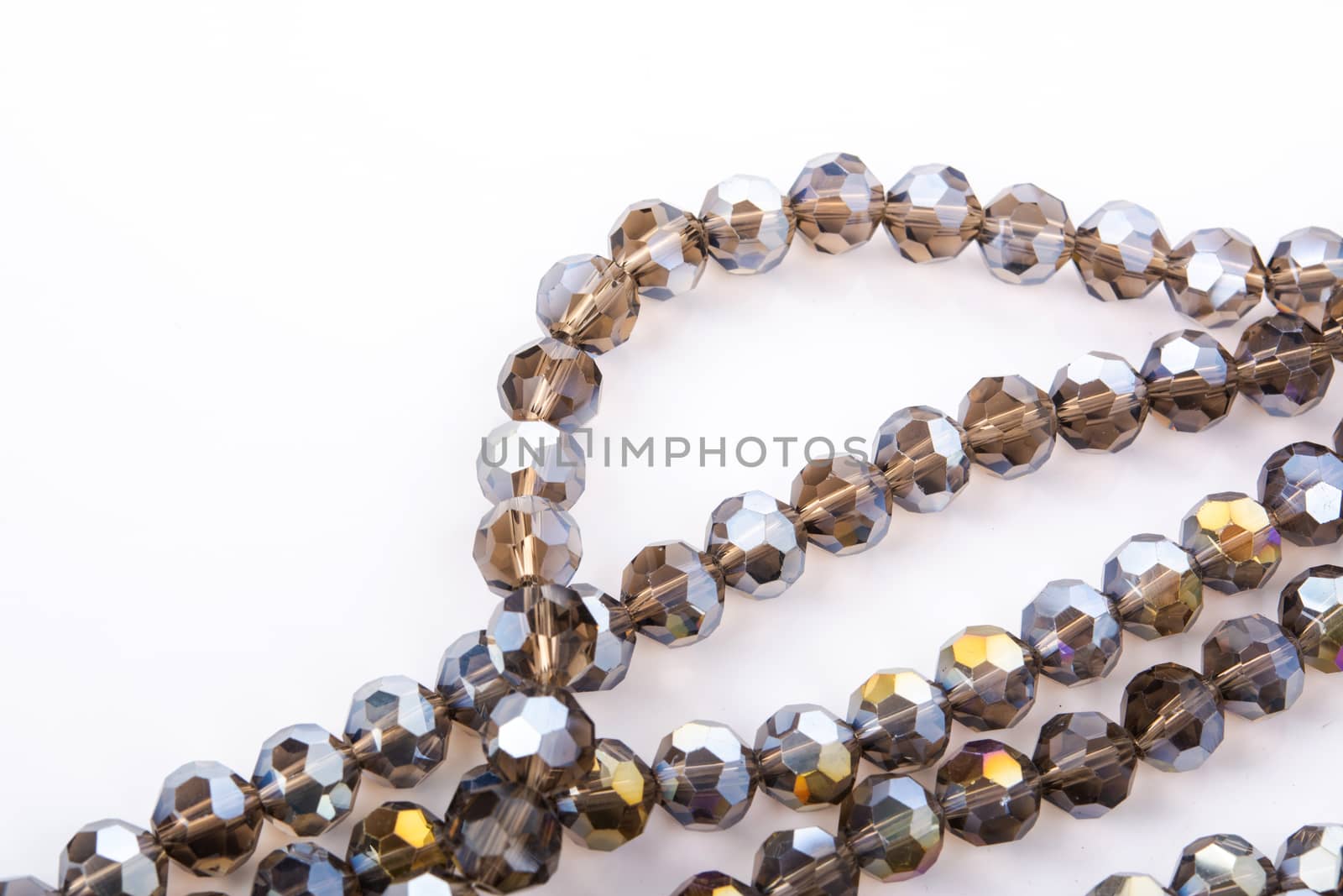 Beautiful gold beige brown Glass Sparkle Crystal Isoalted Beads on white background. Use for diy beaded jewelry. Space for text