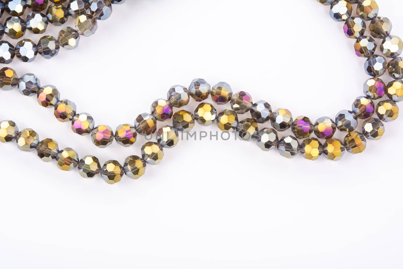 Beautiful gold beige brown Glass Sparkle Crystal Isoalted Beads on white background. Use for diy beaded jewelry. Space for text