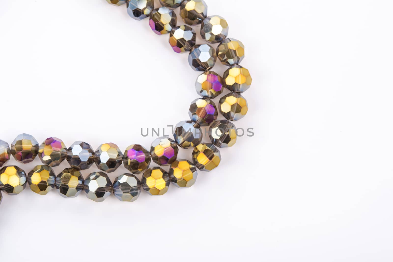 Beautiful gold beige brown Glass Sparkle Crystal Isoalted Beads on white background. Use for diy beaded jewelry. Space for text