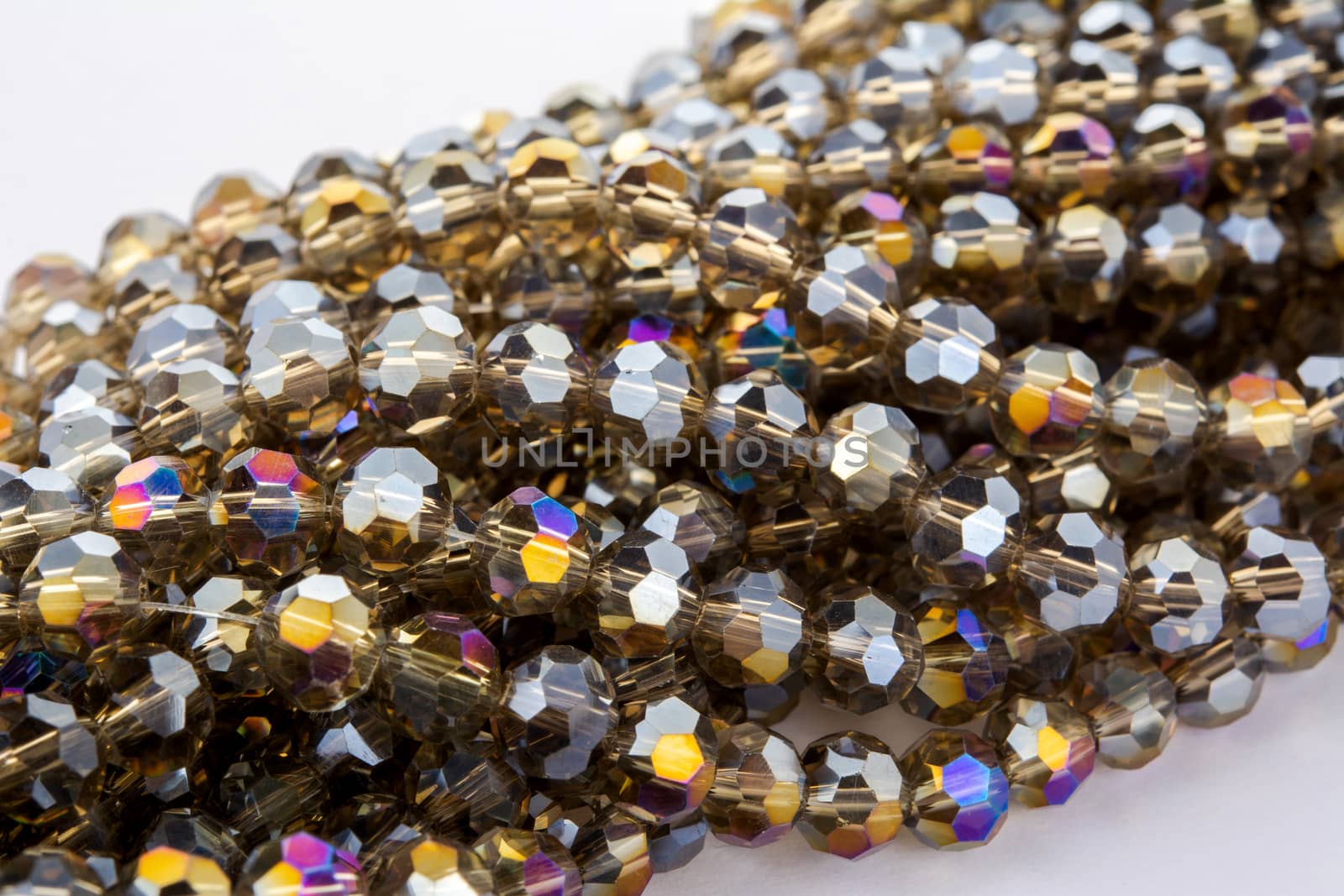 Beautiful gold beige brown Glass Sparkle Crystal Isoalted Beads on white background. Use for diy beaded jewelry. Space for text