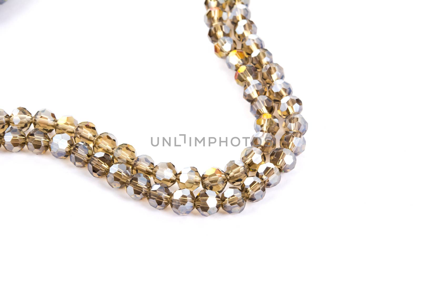 Beautiful gold beige brown Glass Sparkle Crystal Isoalted Beads on white background. Use for diy beaded jewelry. Space for text