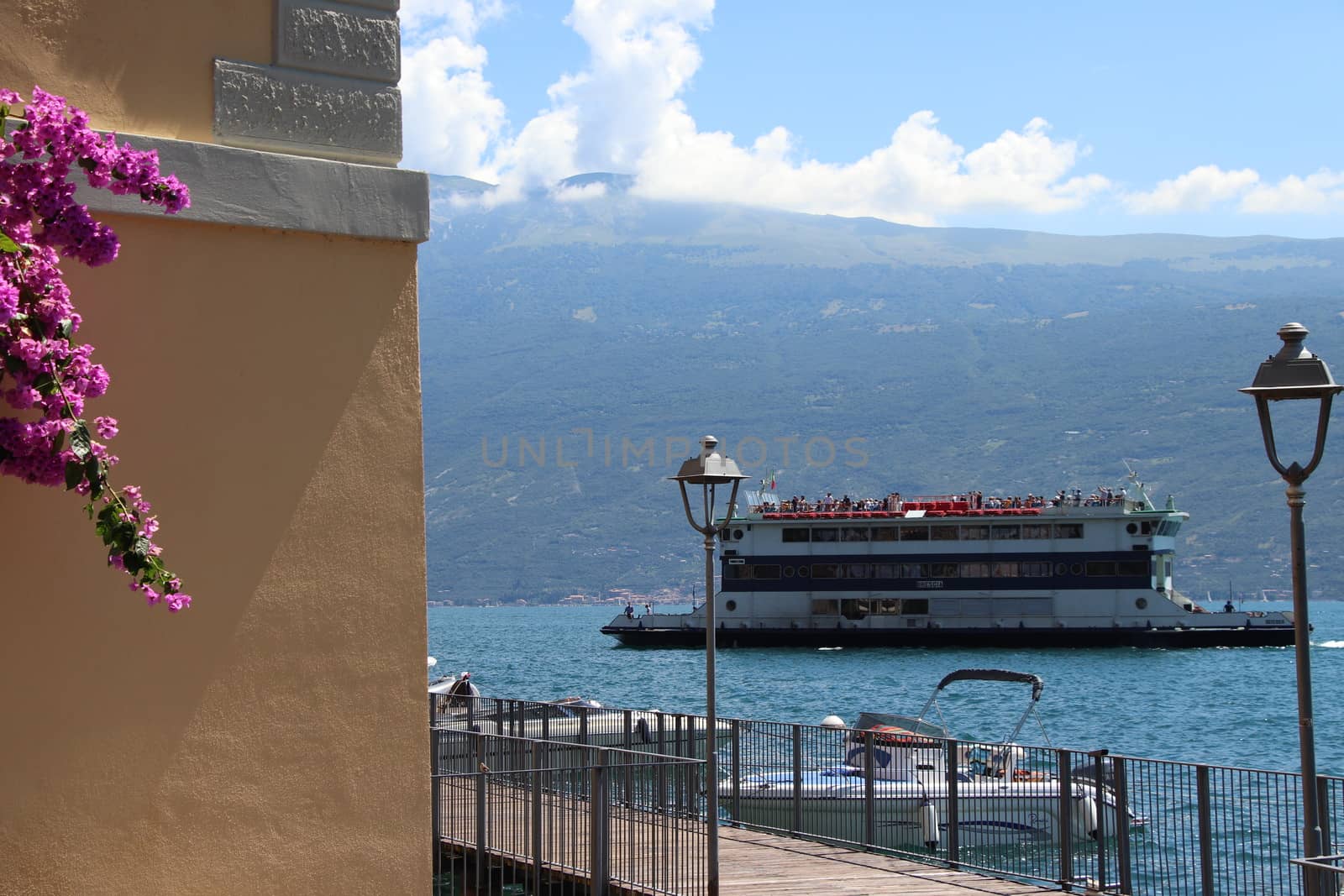 Lake Garda, Brescia,  Italy - 07/ 30/ 2020: An old paddle steamer boat on  Garda lake