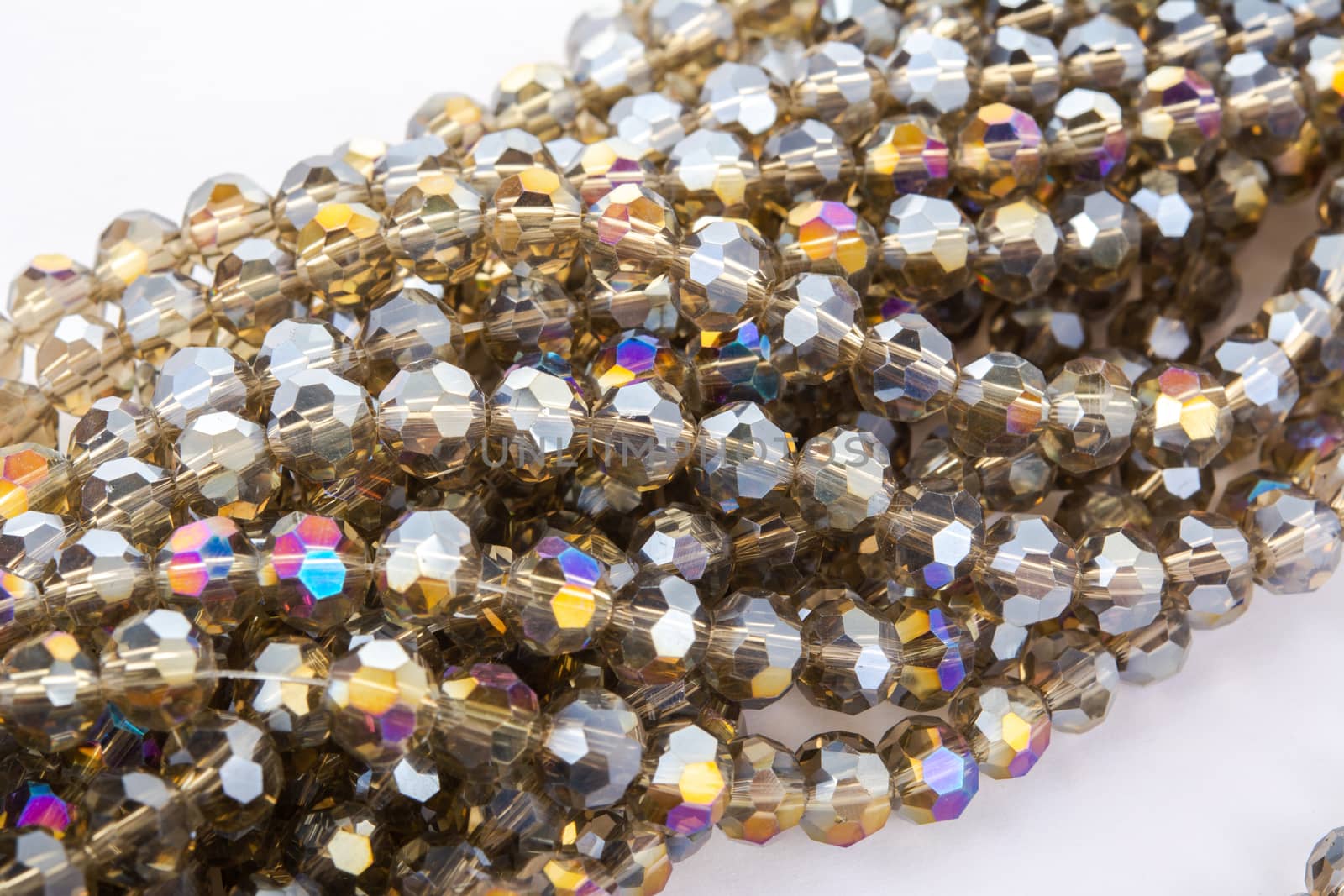 Beautiful gold beige brown Glass Sparkle Crystal Isoalted Beads on white background. Use for diy beaded jewelry. Space for text