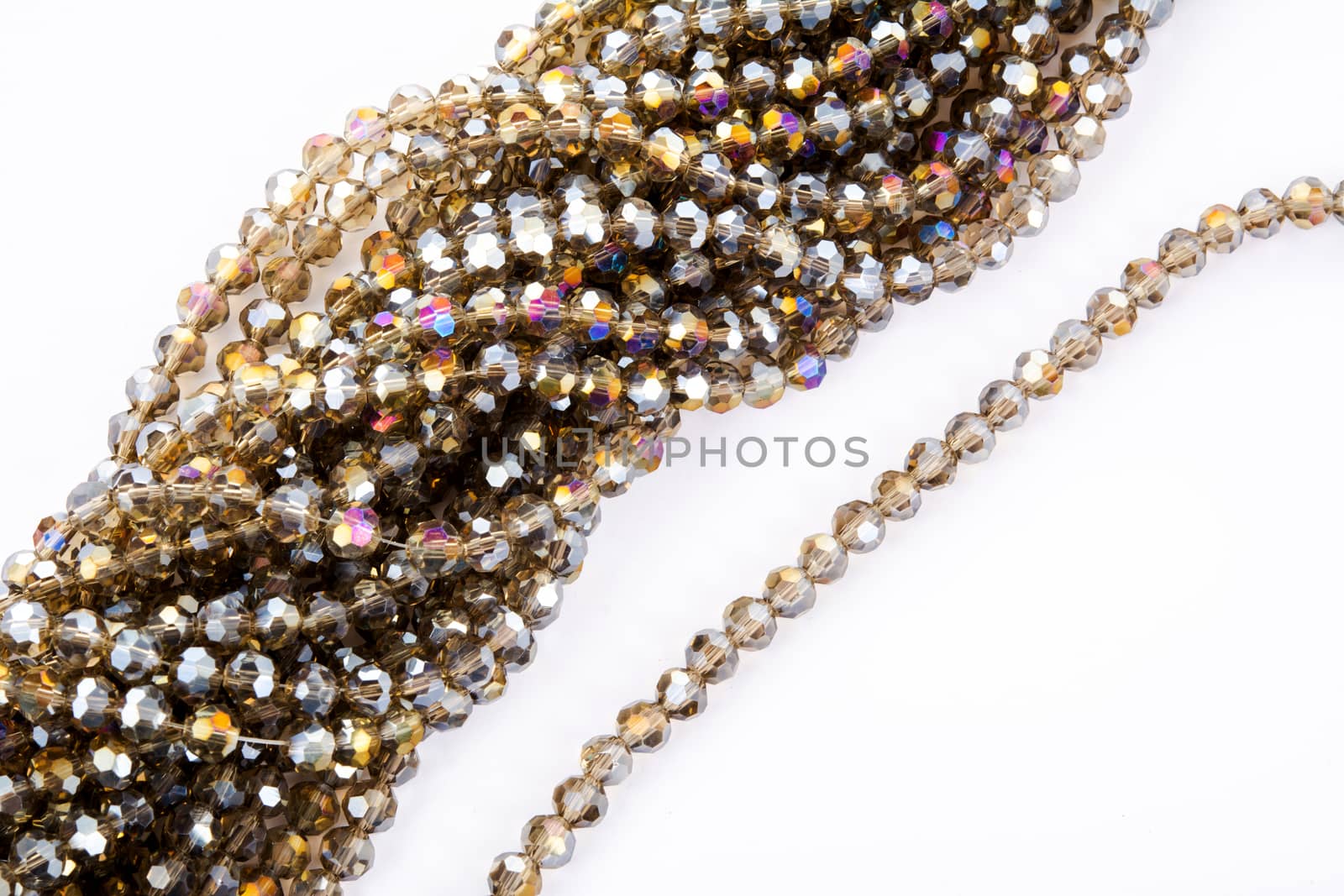 Beautiful gold beige brown Glass Sparkle Crystal Isoalted Beads on white background. Use for diy beaded jewelry. Space for text