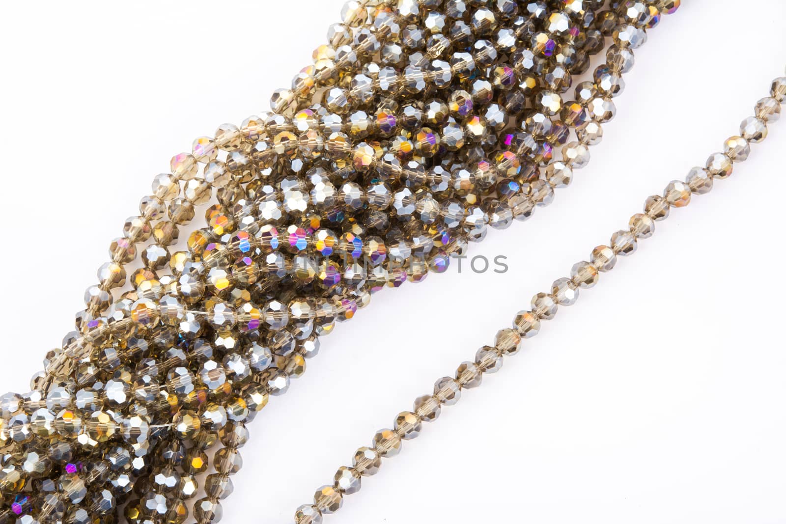 Beautiful gold beige brown Glass Sparkle Crystal Isoalted Beads on white background. Use for diy beaded jewelry. Space for text