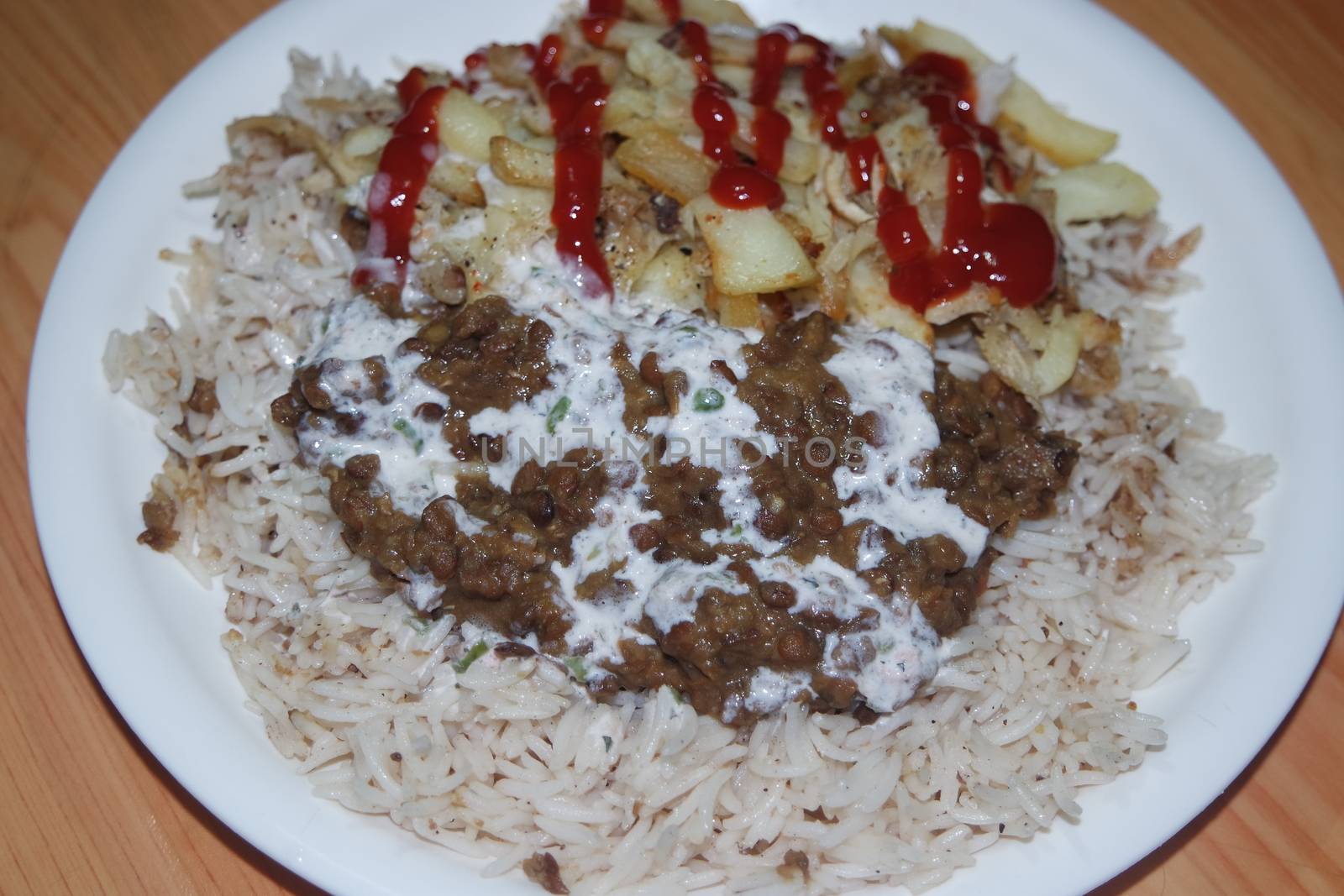 Delicious traditional dish of rice with potato fries and cereals with red ketchup. Food background with copy space for text and advertisements.