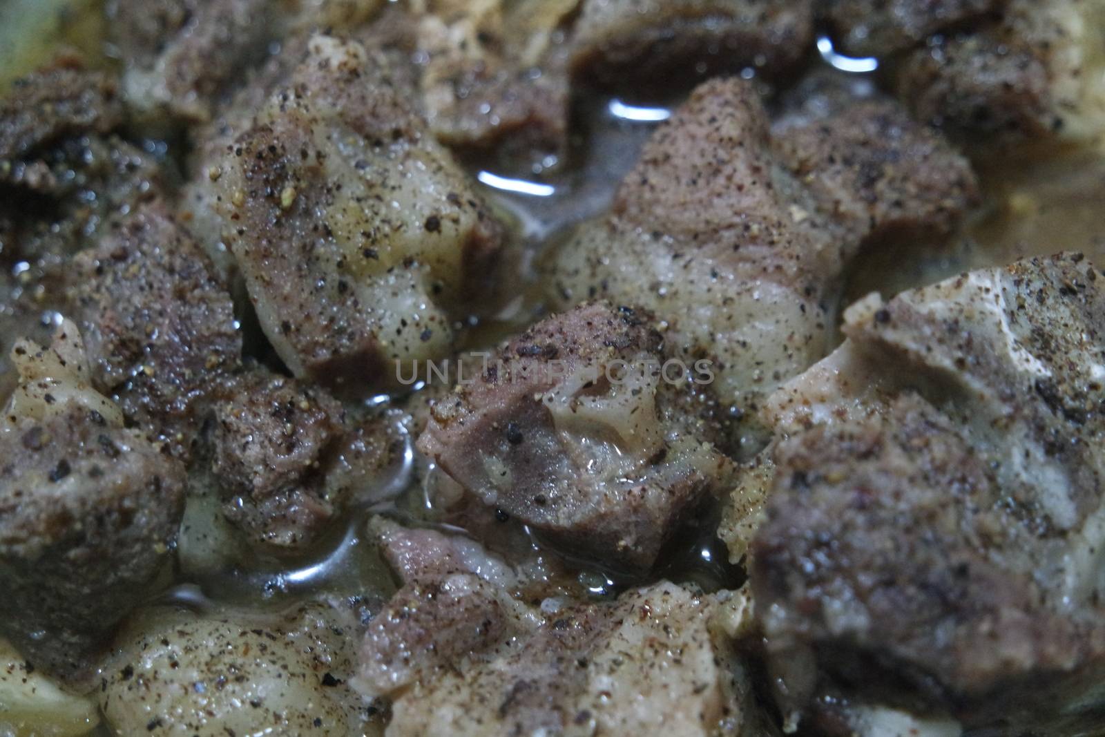 Top view of siri paaye or paya dish garnished with diced ginger, long coriander and black pepper. This dish is popular in Pakistan and Bangladesh
