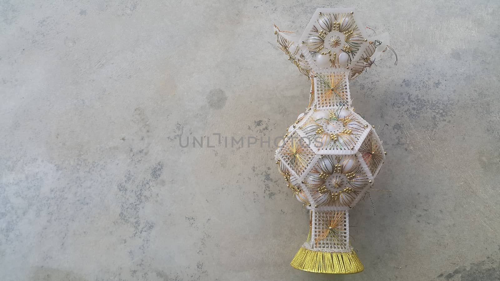 A beautiful ceramic vase placed on a grey floor used for flowers or bouquet by Photochowk