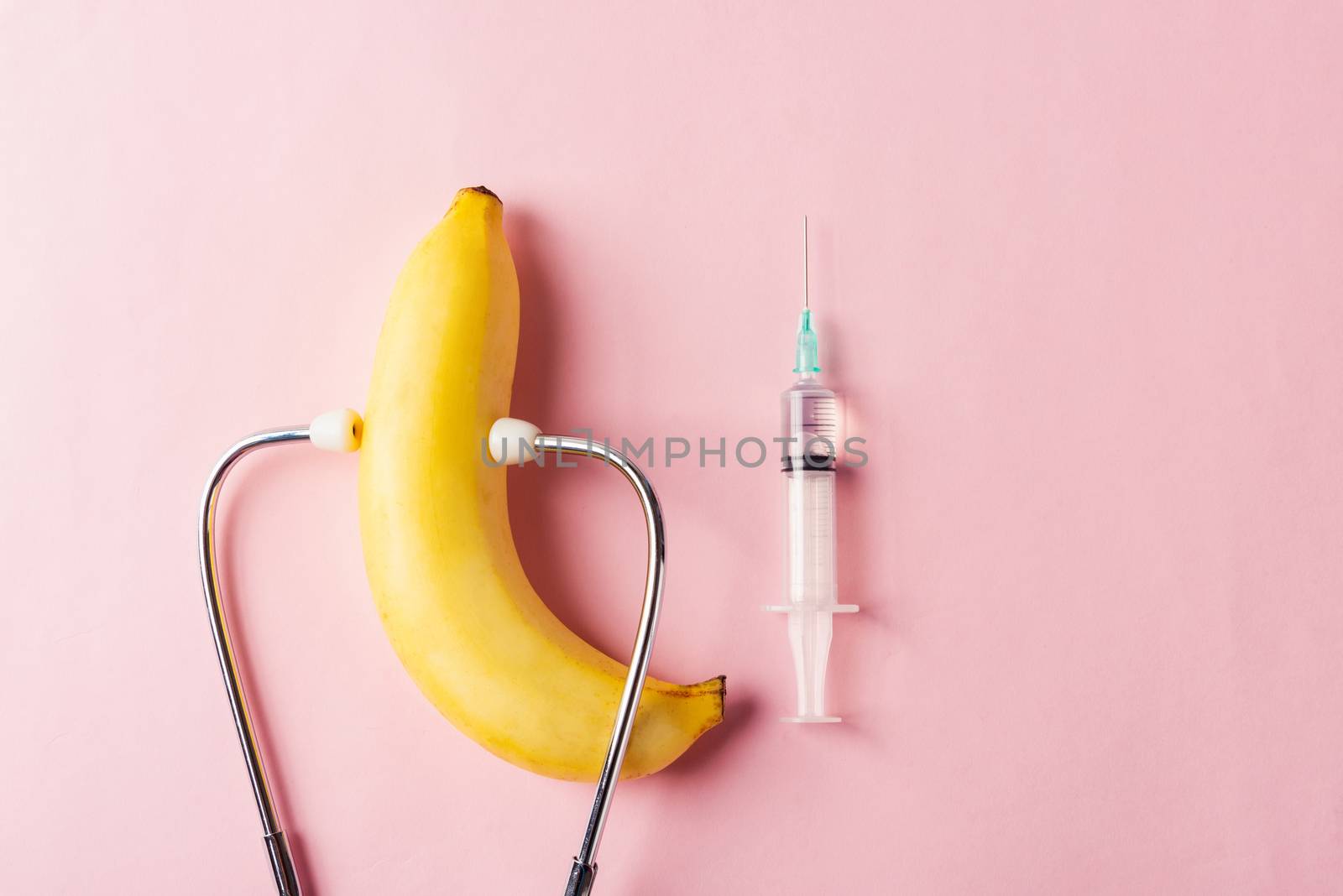 World sexual health or Aids day, Top view flat lay condom in wrapper pack, syringe and doctor stethoscope, studio shot isolated on a pink background, Safe sex and reproductive health concept