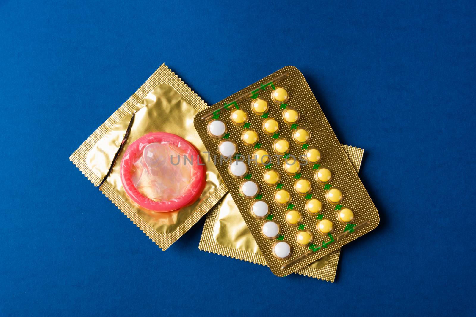 condom on wrapper pack and contraceptive pills blister hormonal  by Sorapop