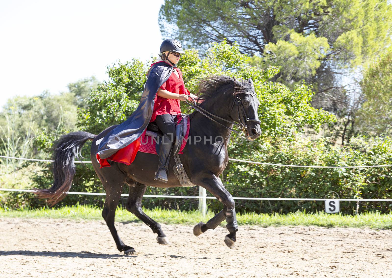  riding girl are training her black horse