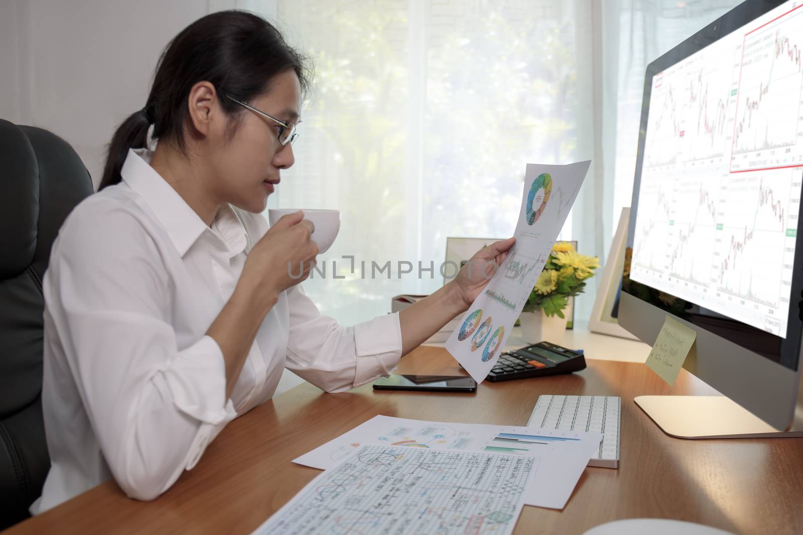 Asian business women working at home online meeting with video conference on computer. Business people using computer online meeting and speaking with team group.