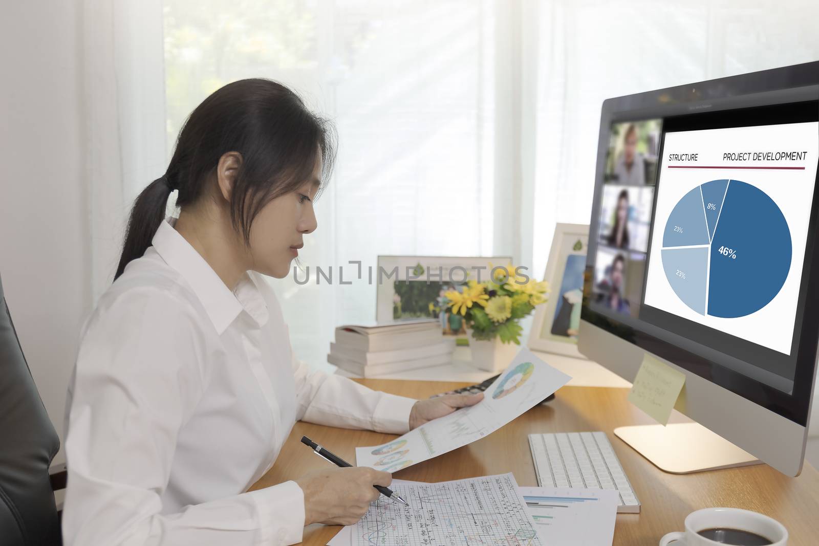 Asian business women working at home online meeting with video conference on computer. Business people using computer online meeting and speaking with team group.