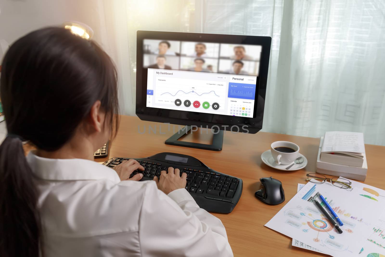 Asian business women working at home online meeting with video conference on computer. Business people using computer online meeting and speaking with team group.