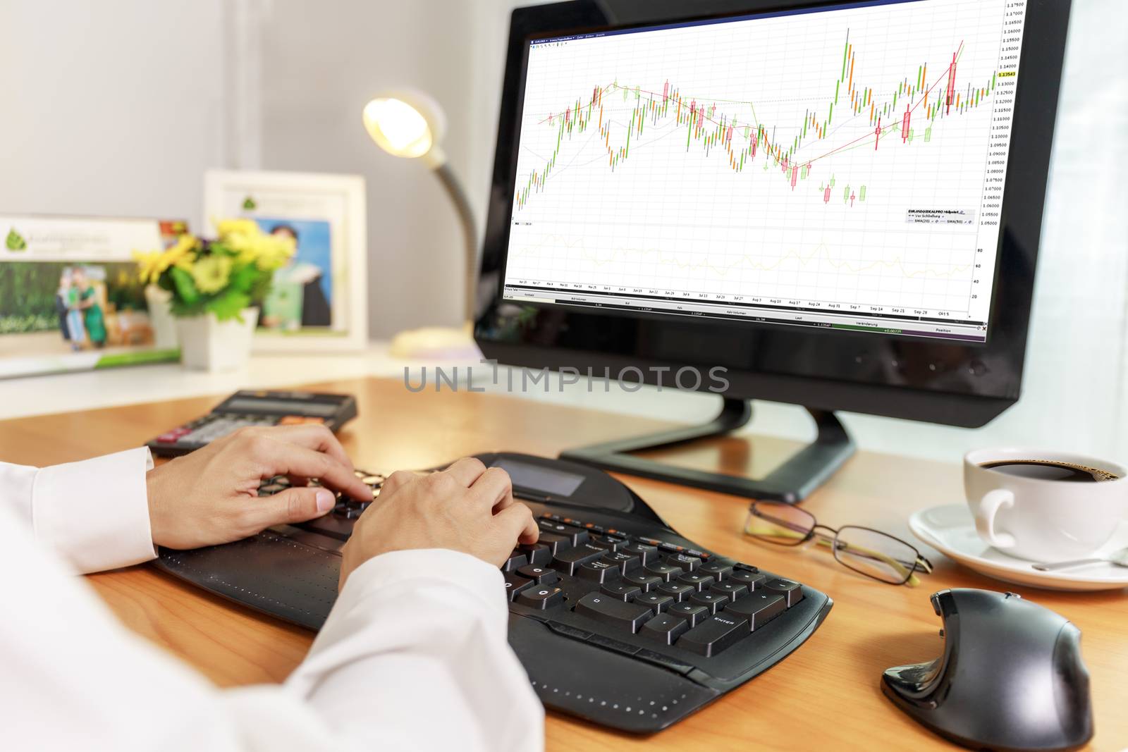 Business and financial concept  Hands of business women use PC computer trade stock market with candlestick chart on screen. Business women use computer network control trade buy and sell at home stock market.