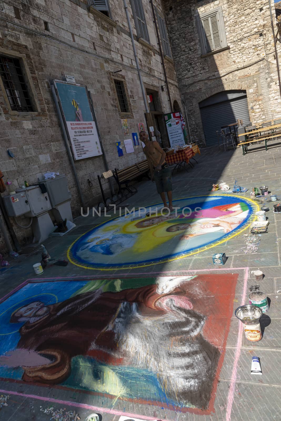 street artist and his works drawn on the ground by carfedeph