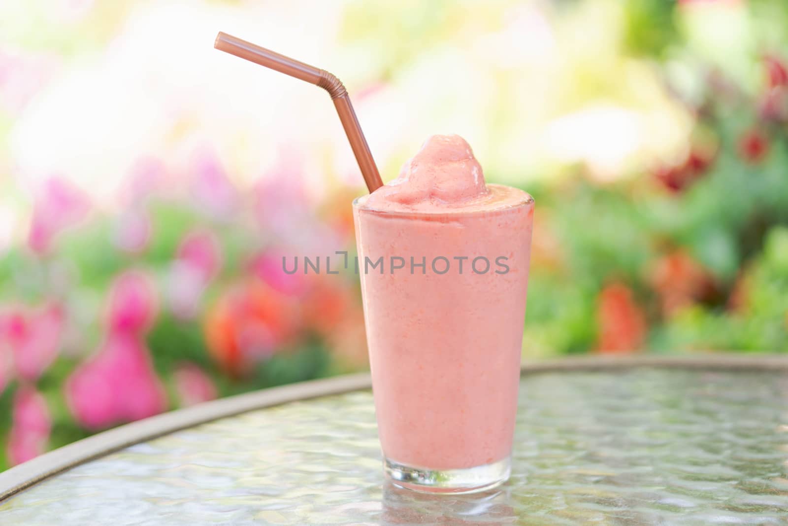 Closeup strawberry smoothie on wood table, selective focus