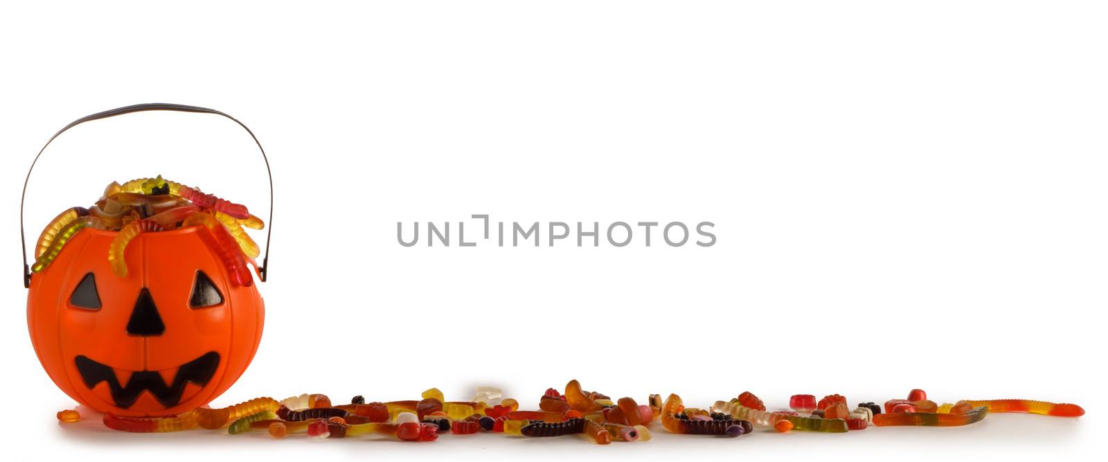 Halloween Jack o Lantern candy collector with worm candy isolated on white background