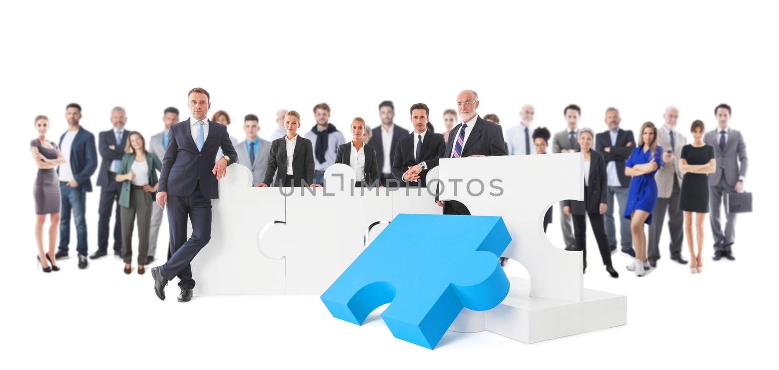 Business teamwork and cooperation concept . Portrait of group of business people with giant puzzle pieces . Partnership and collaboration concept, studio isolated on white background