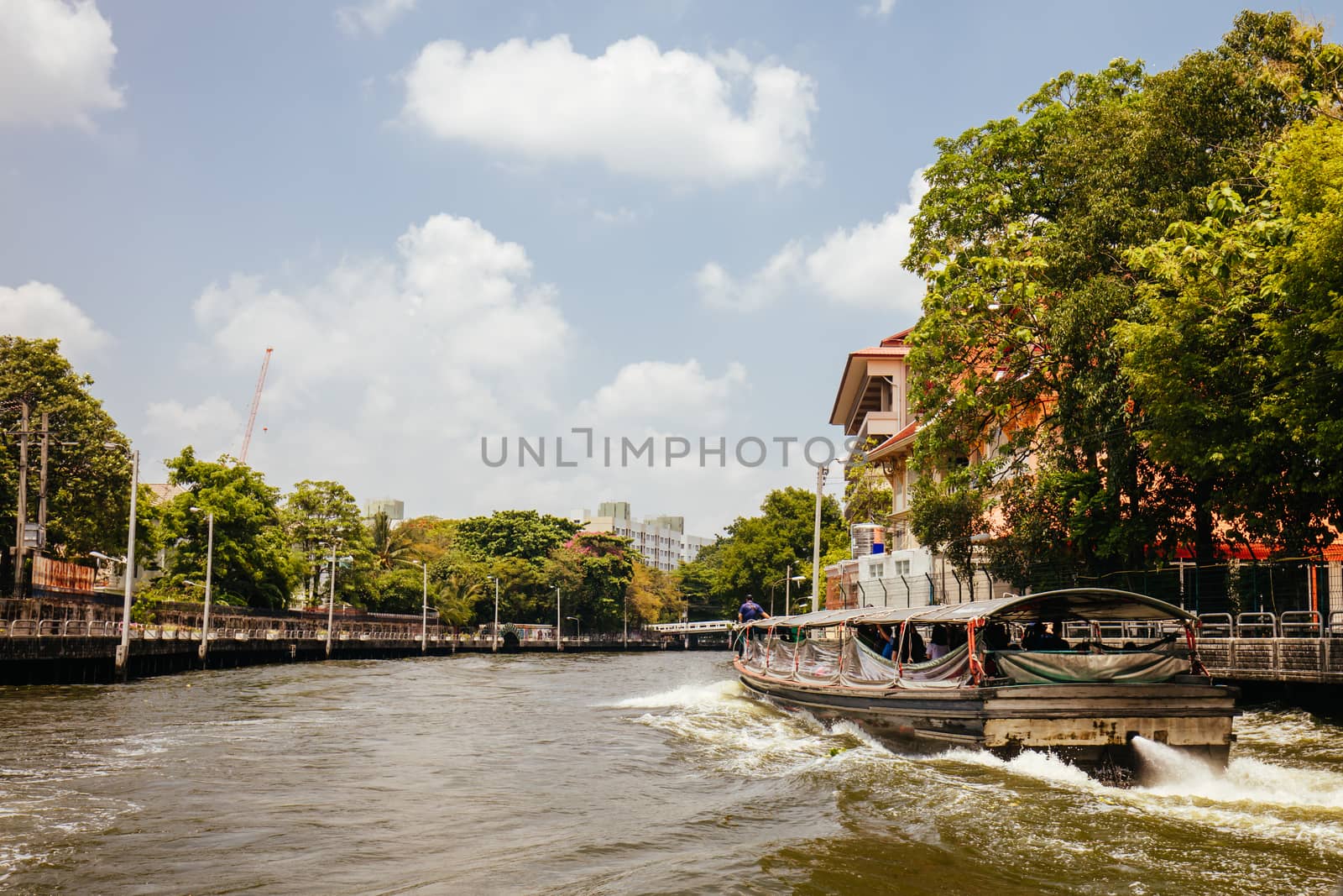 Bangkok, Thailand - April 21 2018: Boat travel in the canals of Bangkok on a hot sunny day