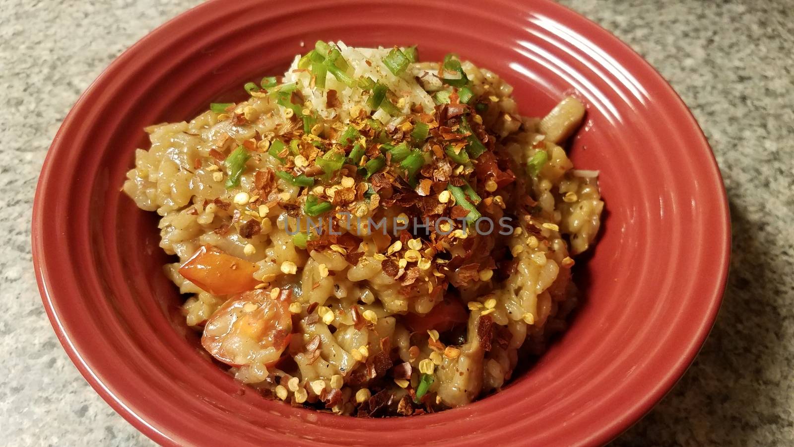 risotto rice with onion and red pepper in bowl by stockphotofan1