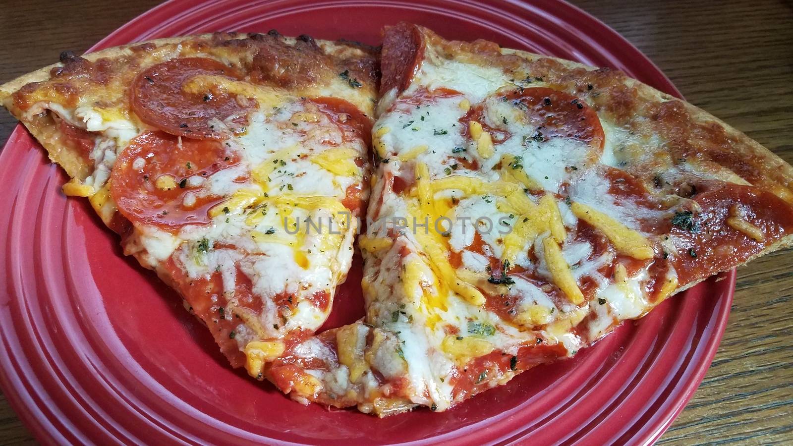 pepperoni and cheese slices of pizza on red plate