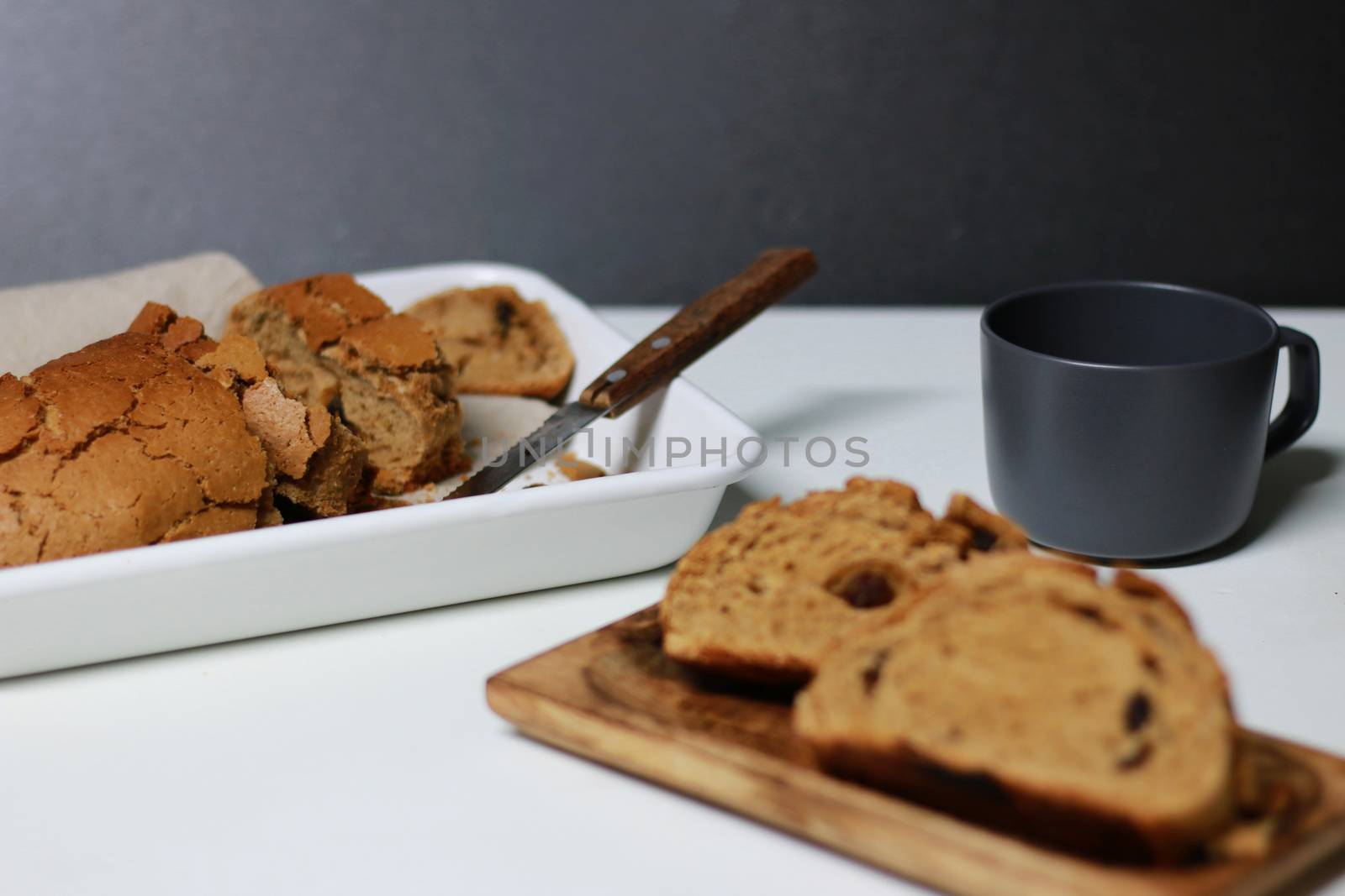 Two slices of bread and mug on table by uphotopia