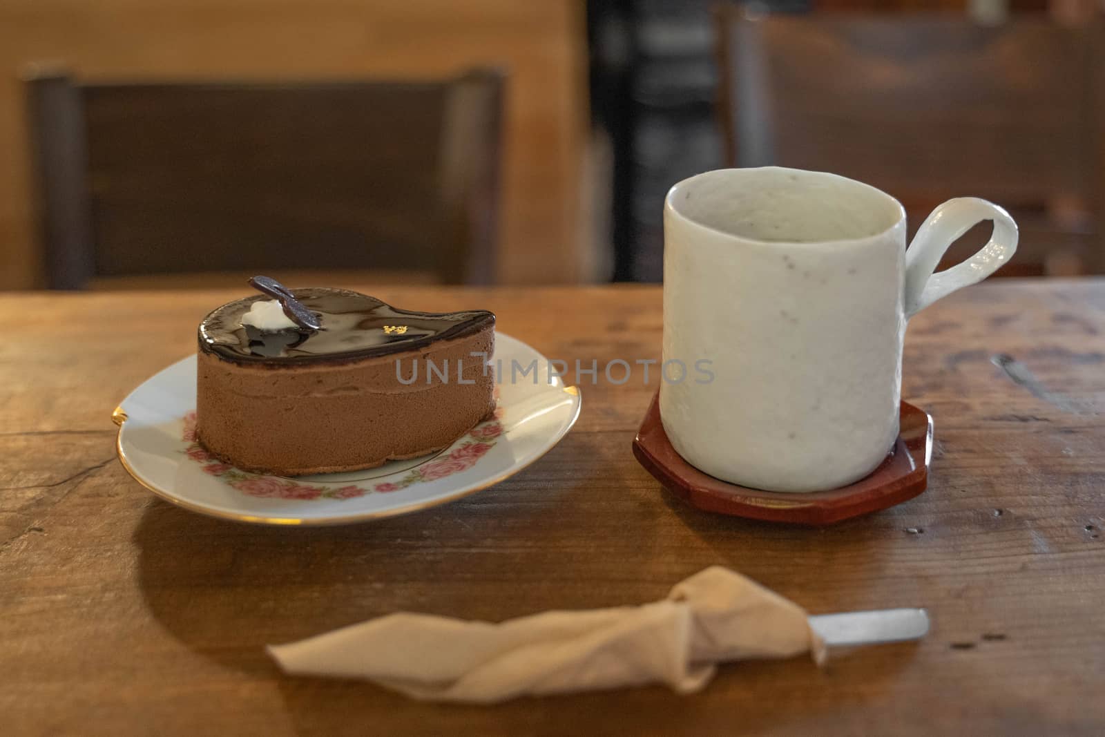 Cake and cup of coffee on wooden table by uphotopia