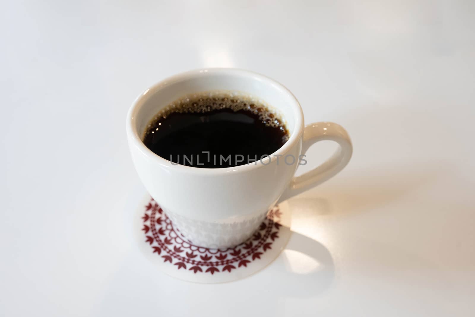 Cup of coffee on white background by uphotopia