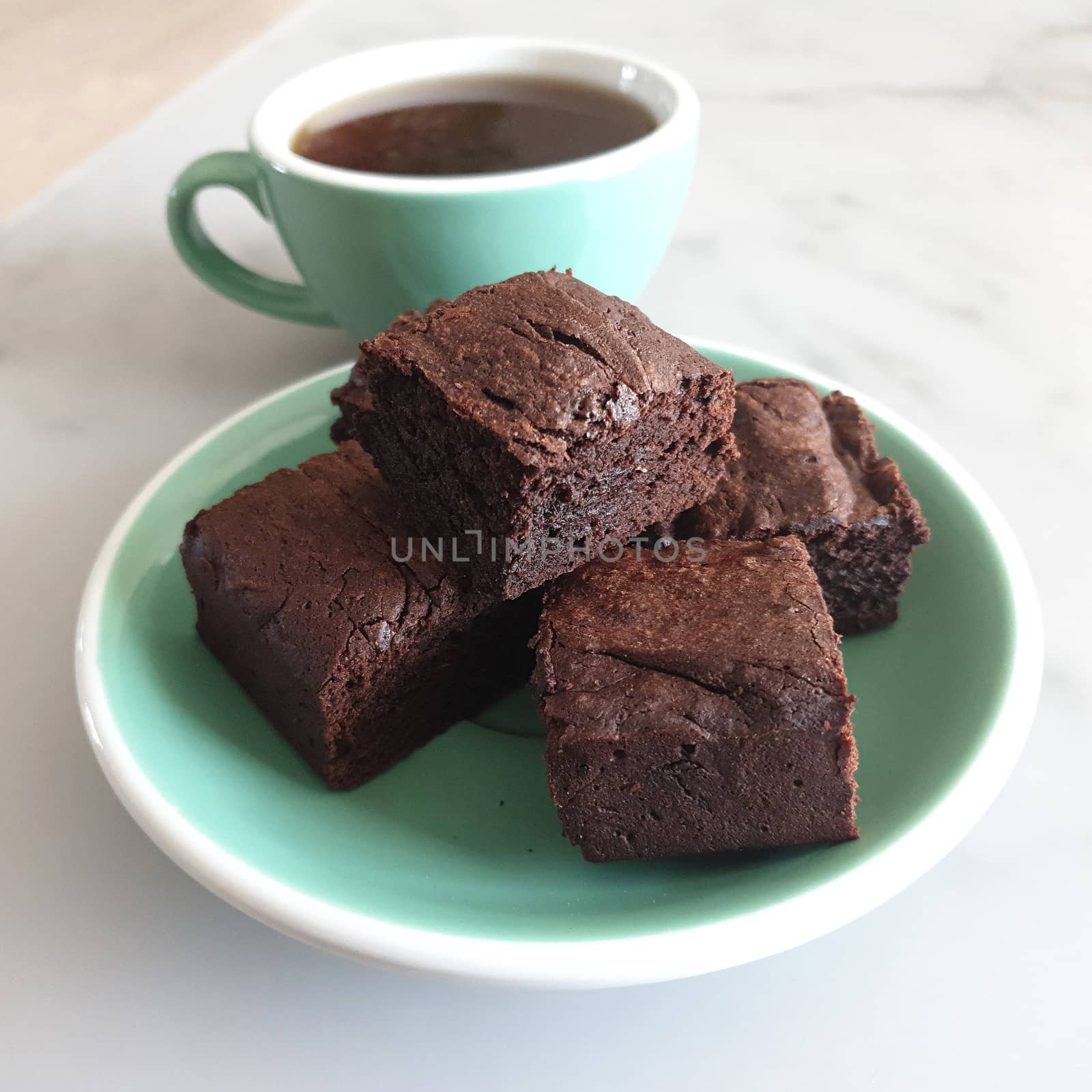 Four slices brownie and cup of coffee by uphotopia