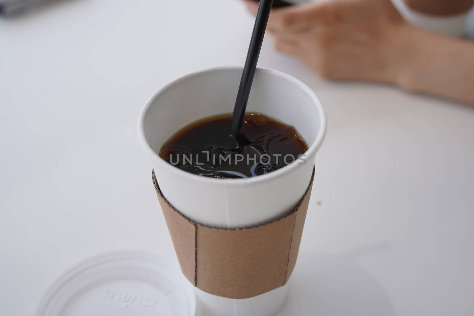 Pouring black coffee into cup