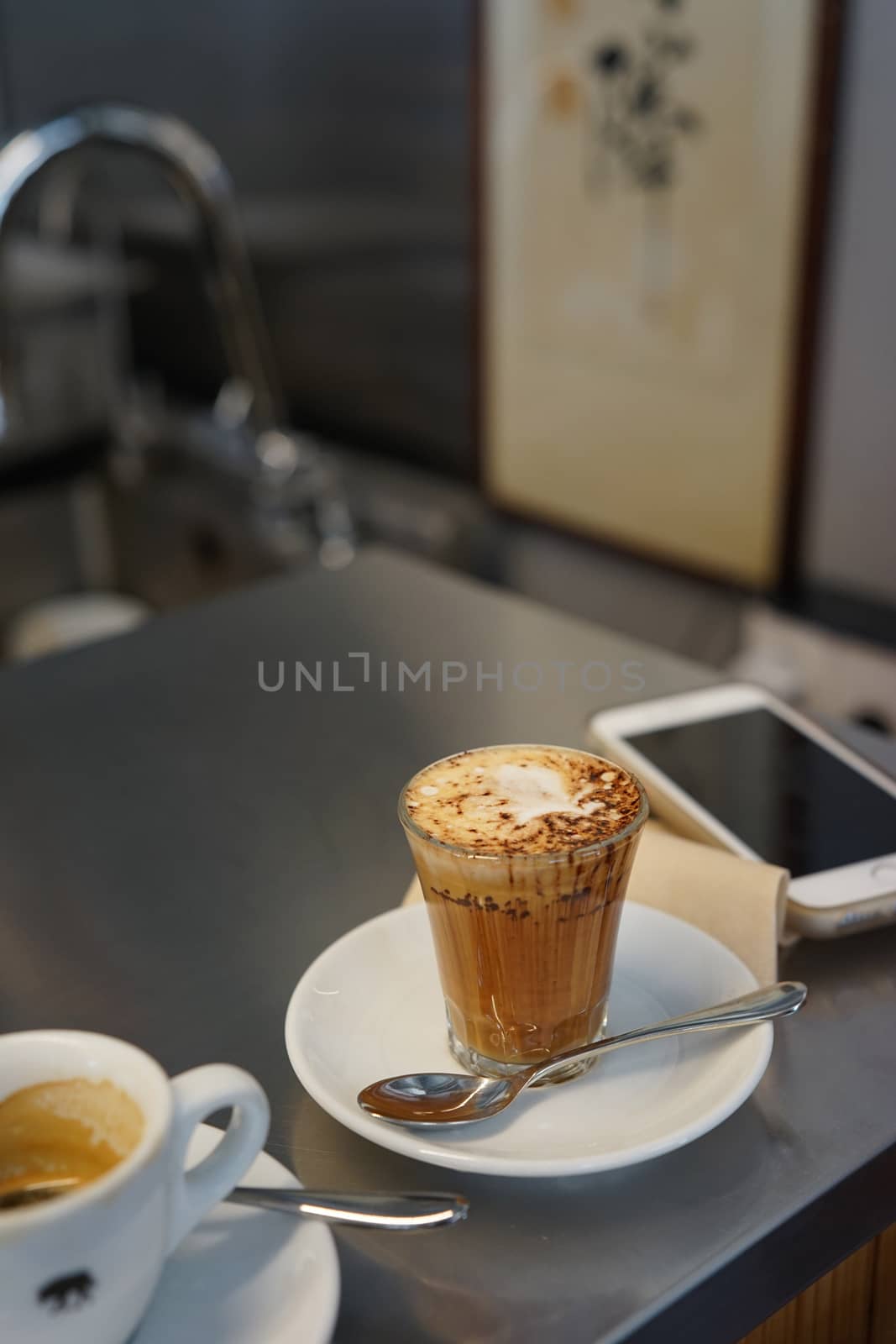 Smartphone and two cups of iced coffee by uphotopia