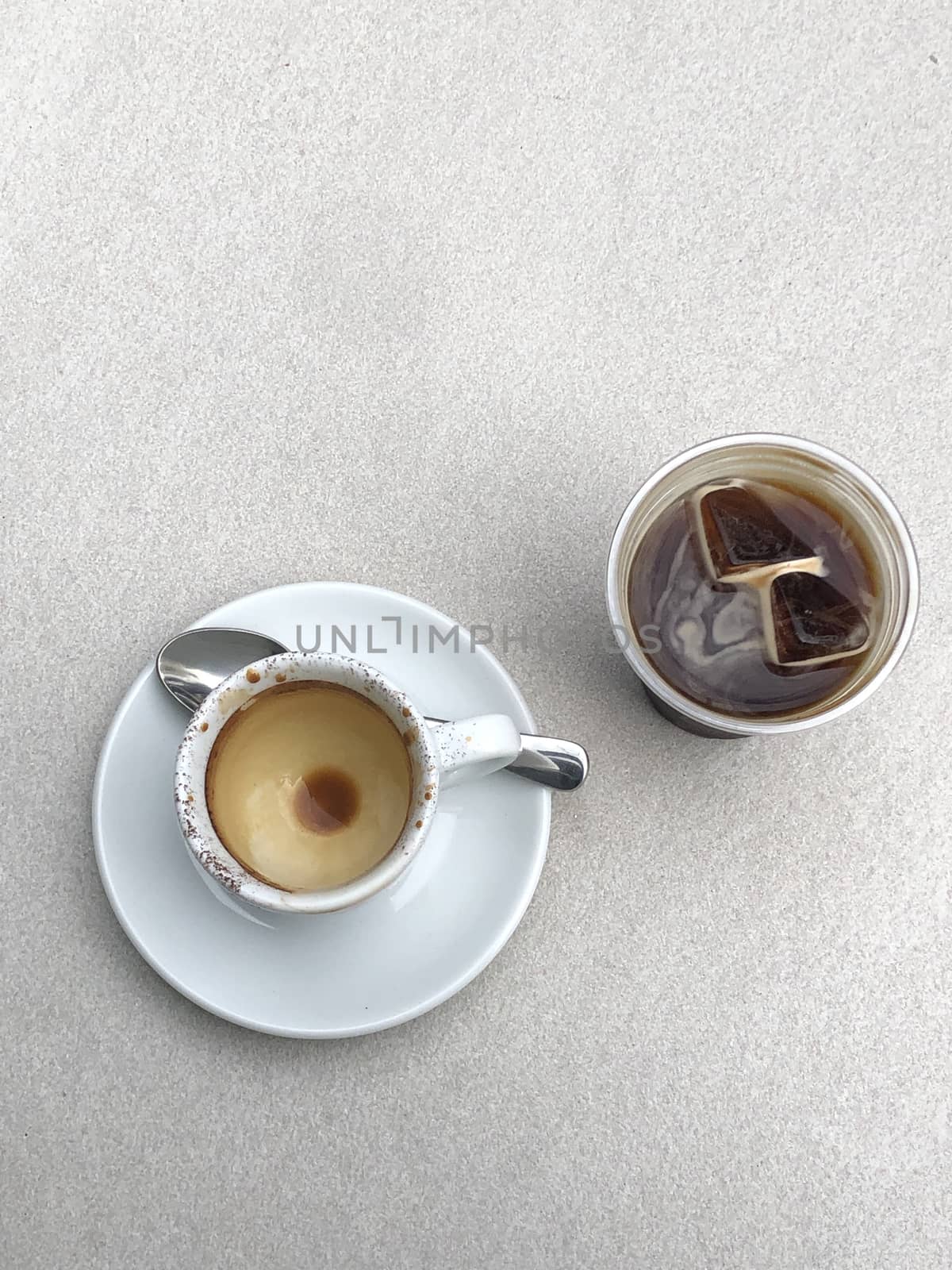 Two cups of coffee on white table by uphotopia