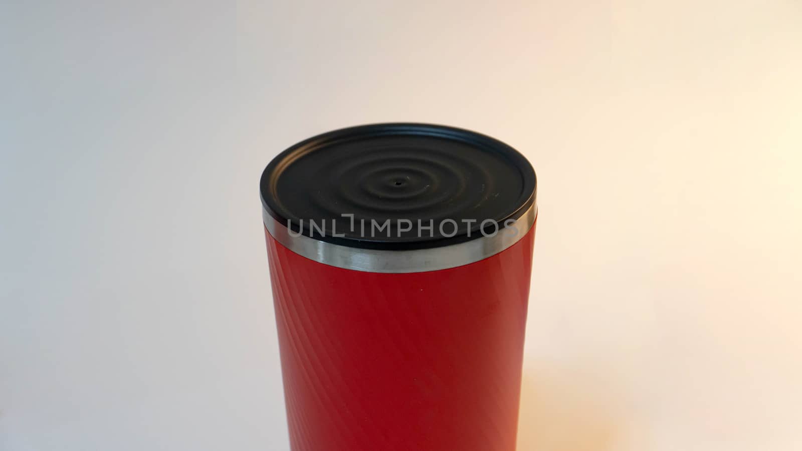 Red tumbler on white background by uphotopia