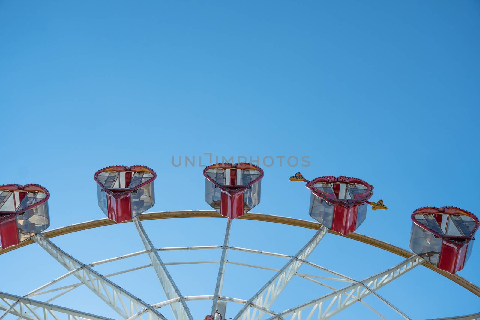 Ferris wheel with cabins in the shape of hearts on a background  by YevgeniySam