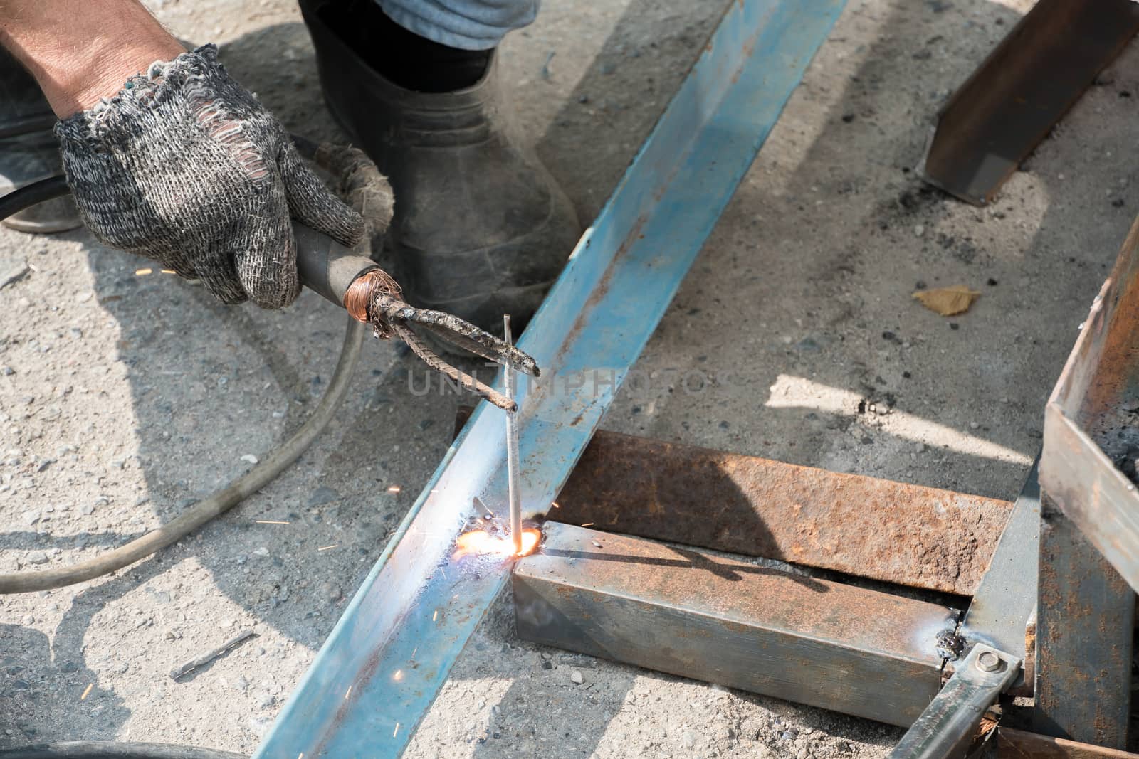 Welder welds metal structure. Construction worker at work. A wor by YevgeniySam