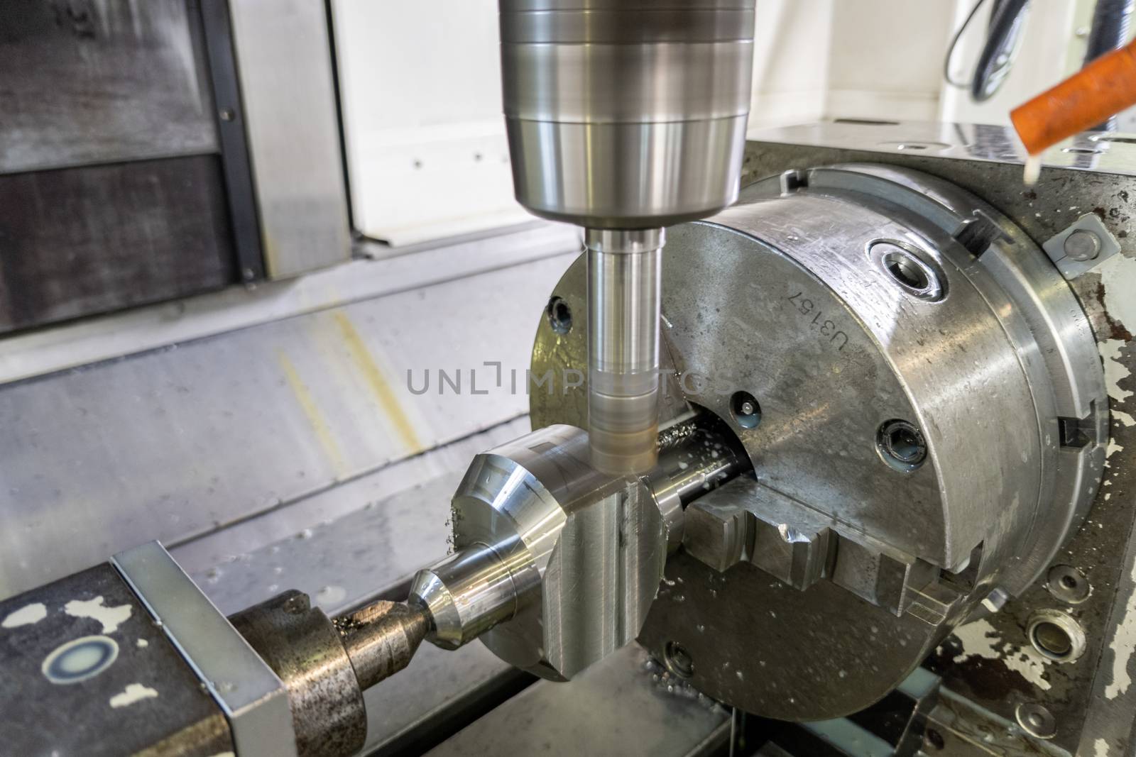 unadorned photo of automated milling metal part on vertical cnc machine
