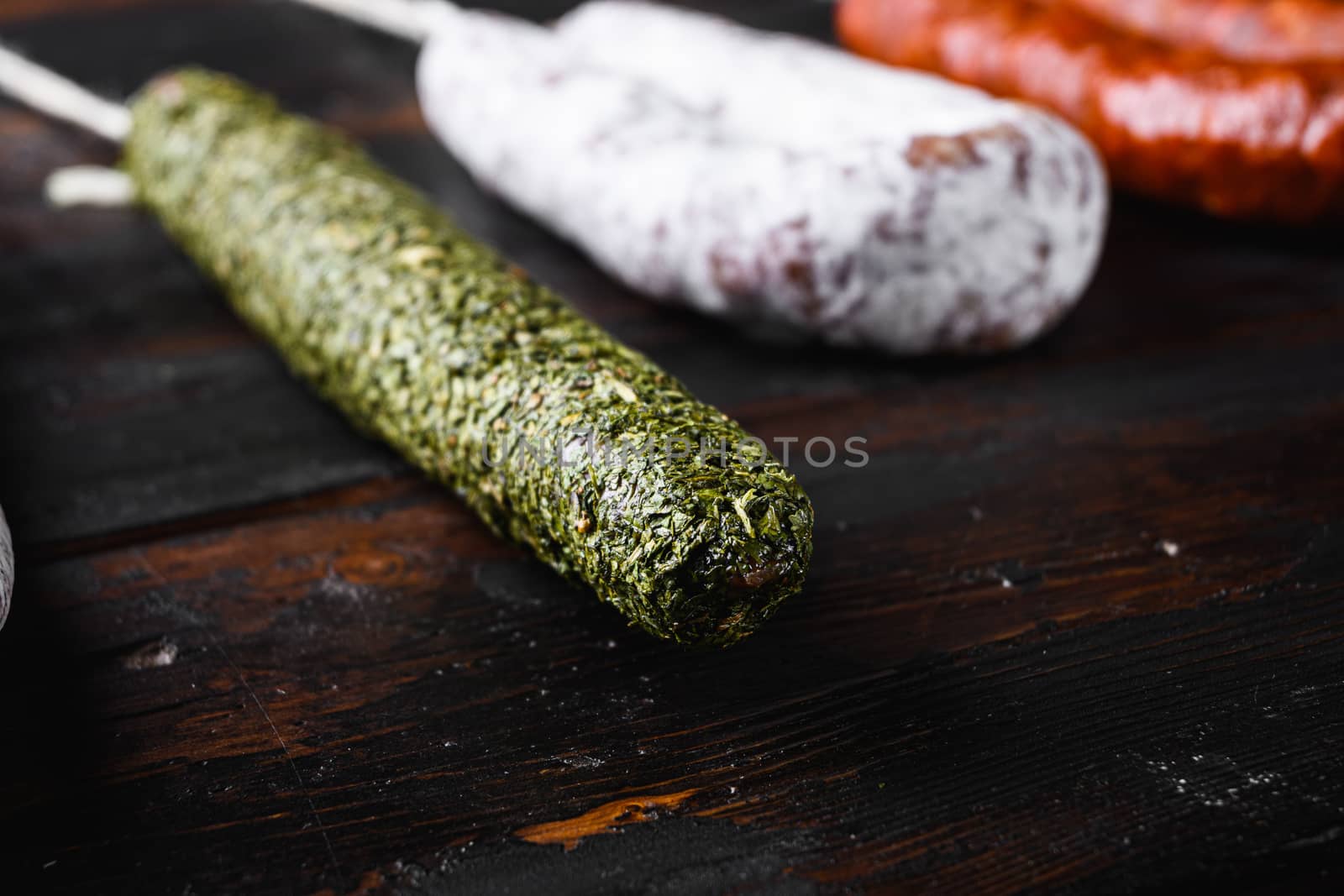 Spanish dry sausages on wooden background.