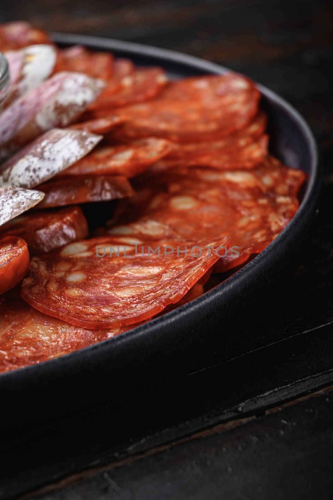 Spanish cold meat plate, chorizo, fuet, lomo,longaniza and salchichon on wooden table.